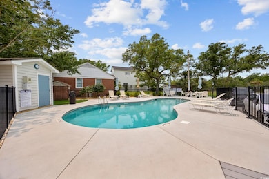Community pool featuring a patio