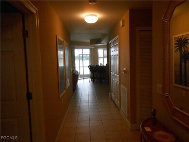 Corridor featuring tile patterned floors and baseboards
