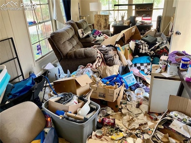 This is a hoarding situation. Living room is on your right as you enter.
