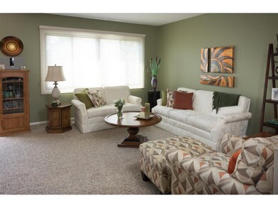 Living room features custom window treatments and 
