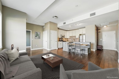 Virtually staged living room looking back at kitchen - stagered ceiling for more interest and hiding duct work.