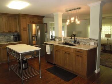 Kitchen with newer cabinets and quartz countertop.