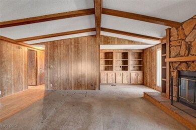 Unfurnished living room with vaulted ceiling with