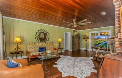 Living area with wooden ceiling, a ceiling fan, wo