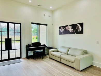 Living room featuring a towering ceiling, visible 