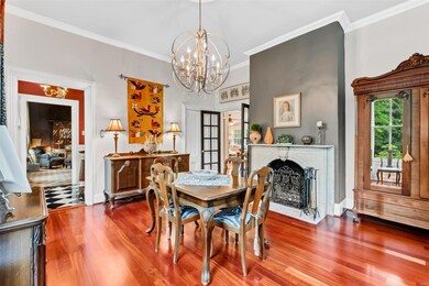 A view from the dining room through the front entry hall into the library/music room. The double doors lead to the kitchen.