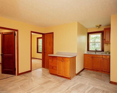 Kitchen with a textured ceiling, light countertops