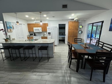 Dining space with vaulted ceiling, sink, and ceiling fan