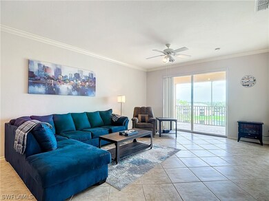 Living room with a wood stove, crown molding, ceil