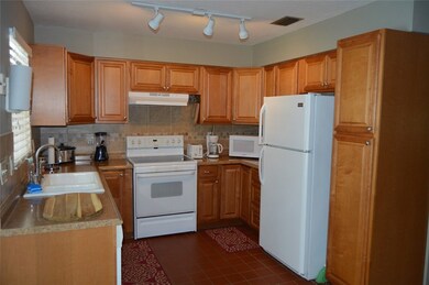 VIEW OF KITCHEN FROM DINING AREA