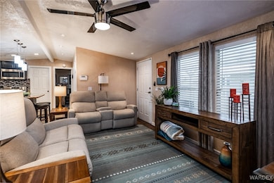 Living room featuring a textured ceiling, vaulted