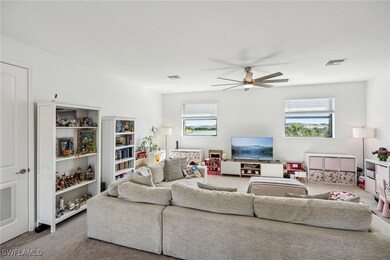 Living room featuring carpet floors, visible vents