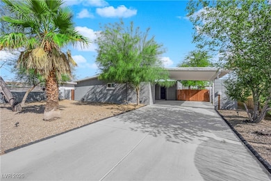 View of front facade with concrete driveway, an at