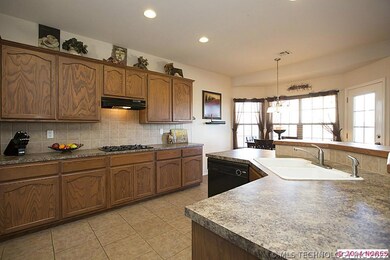 Large center island Kitchen boasts gas cook top, g