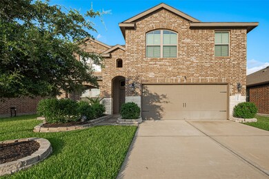 Beautiful brick facade with arched entry, lush lan