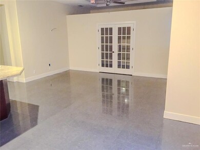 Spare room with ceiling fan and french doors