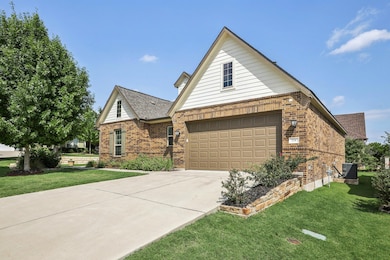 View of front of home featuring brick siding, a g