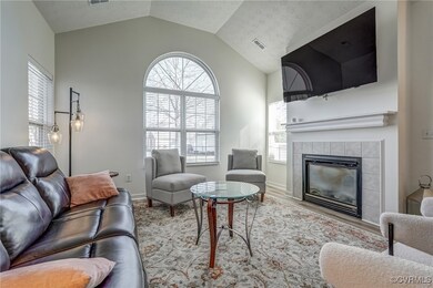 Living area featuring vaulted ceiling, wood finish