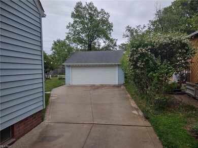 Two car garage with newer door  and floor.