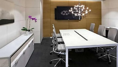 Office area featuring tile walls and a chandelier