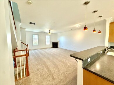 The view from the Kitchen into the Family Room with new carpeting, fresh paint and warm fireplace.
