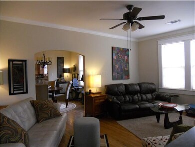 Opposite view of living room opens with archway in