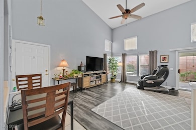 Living area with baseboards, wood finished floors,