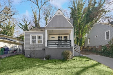 Bungalow featuring a front yard, covered porch, fe