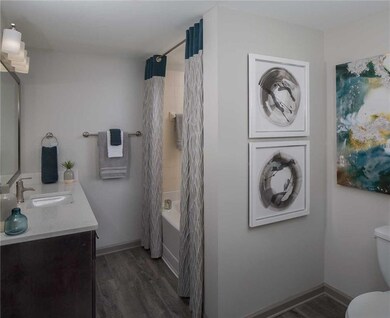 Full bathroom featuring wood-type flooring, vanity