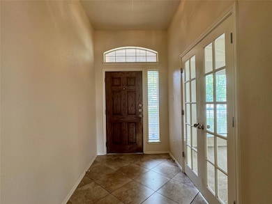 Tiled entryway with plenty of natural light, fren