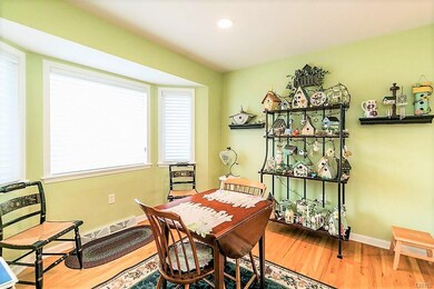The sunny bay window floods the breakfast nook wit