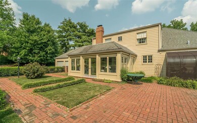 Back of home with brick patio