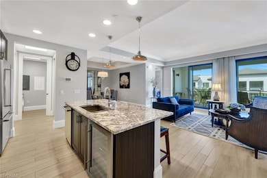 Kitchen with wine cooler, a sink, stainless steel 