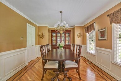 Formal dining room features oak floors with custom