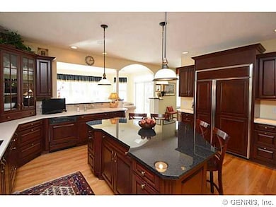 Kitchen. Cherry Cabinetry with display cabinets, island with granite and breakfast bar.