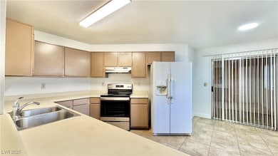 Kitchen featuring white refrigerator with ice disp