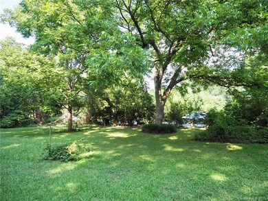 Rear view of yard and mature trees.