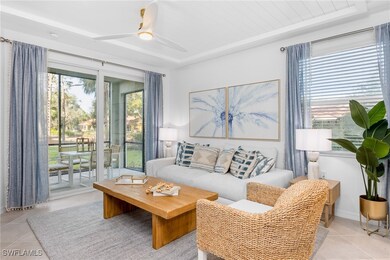Living area featuring light tile patterned floors and a ceiling fan