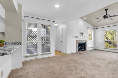Unfurnished living room featuring vaulted ceiling,