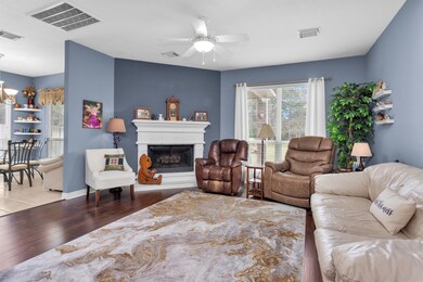 The living room with a gas log fireplace.