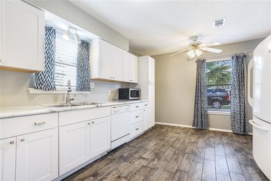 Open kitchen with updated cabinets, countertops an