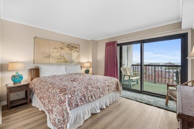 Bedroom featuring light wood-style flooring, crown molding, and access to outside