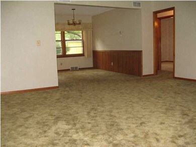 Large living room-wood floors under carpet in livi