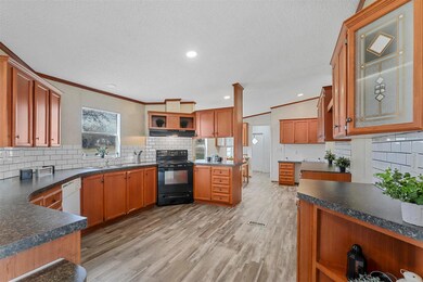 Kitchen featuring crown molding, light hardwood / 