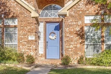View of exterior entry with brick siding