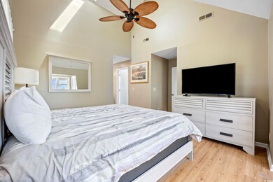 Bedroom featuring ceiling fan, light wood-type flo