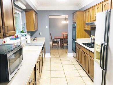 Kitchen offers Corian countertops and pot drawers.