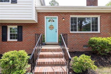 View of exterior entry with brick siding