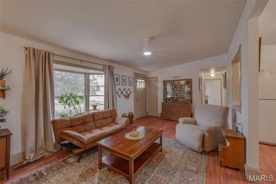 Living area featuring a ceiling fan and wood finished floors