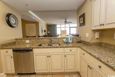 Kitchen with ceiling fan, light stone counters, di